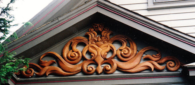 Custom hand carved wood owl in gable, architectural woodcarving, unique, distinctive and personalized carving for McConnel residence